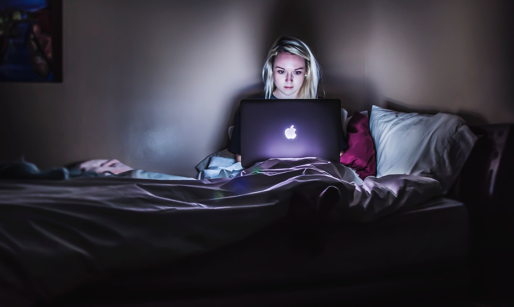 Woman using laptop at night